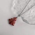 Macro detail of red glass Christmas tree pendant on silver stainless steel chain - Silver-Red Green