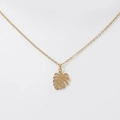 Macro detail of 18K gold monstera leaf pendant on a stainless steel necklace chain - Monstera Leaf - Gold (DN105)