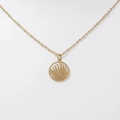 Macro shot of 18K gold palm leaf cutout pendant on a fine stainless steel chain - Palm Leaf - Gold (DN213)