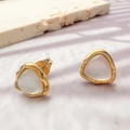 Close-up of triangle cat-eye stud earrings with golden wavy edges on a textured stone - Rounded Triangle Style (DE136-SJX)