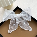 Elegant white lace ribbon scarf with delicate floral patterns and fuzzy ball accents - Lace Pompom White