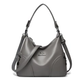 Grey litchi leather crossbody bag for women featuring a metal kangaroo logo and long strap - Gray