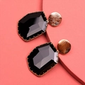 Macro shot of geometric earrings featuring black octagonal crystals in gold claw settings - Black (30396)