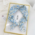 Blue floral pattern chiffon scarf tied in a bow on a decorative gold picture frame - Gradient Blue Floral Beige