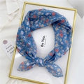 Elegant blue floral cotton linen square scarf with small flower pattern tied in a bow - Red Rose Blue Background