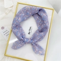 Floral cotton linen scarf in purple and blue leaf print tied in a delicate bow - Bamboo Leaf Purple