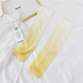 Detail of gradient cream to yellow sun sleeves with orange brand logo on a white fabric - One Size / Gradient Yellow