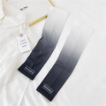 Detail view of grey gradient sun protection sleeves with breathable fabric and logo - One Size / Gradient Black