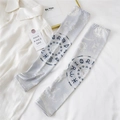 Close-up of light grey sun protection arm sleeves with celestial sun and zodiac pattern - One Size / Zodiac Disc Grey
