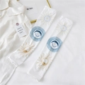 Close-up of white sun and moon print ice silk sun protection arm sleeves on textured fabric - One Size / Sun and Moon