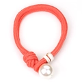 Close-up of orange braided cord necklace with a large pearl and marble pattern beads - Orange Red