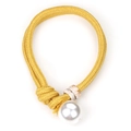 Detailed view of yellow braided cord necklace with a large pearl and marbled beads - Earthy Yellow