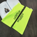 Detail of neon yellow sun protection sleeves with MISUKHO branding on a wooden surface - Neon Yellow with Black Letter
