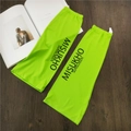 Detailed close-up of neon green ice silk sunscreen sleeves on a dark wood background - Green with Black Letter