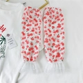 Detail of white lace arm sleeves featuring cherry prints and layered ruffle cuffs - Chiffon Lace Persimmon
