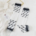 Detail of white cooling arm sleeves with wave pattern and embroidered wrist cuff - Small Geometric C
