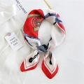 Elegant silk scarf with vintage red and navy prints on a white shirt background - Red Square Saddle