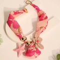Detail of bohemian floral fabric necklace with a pink starfish charm and 3D beige flower - Rose Red