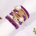Bohemian purple acrylic bead bracelet set with gold heart charm and pearls on display - Purple