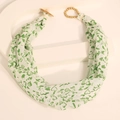Detail of fabric scarf necklace with green hearts and golden toggle clasp on white stand - Green White Heart Fabric Scarf With Gold Buckle (X-909)