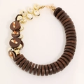 Detail of handmade natural coconut shell necklace with golden beads and wood buttons - Brown/Gold