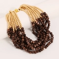 Detail of bohemian layered beaded necklace with marble-patterned and golden beads - Brown