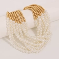 Detail of bohemian multi-layer beaded necklace with white pearls and gold round beads - Faux Pearl