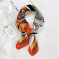 Silk square scarf with yellow and orange geometric patterns styled on a white shirt - Colorful Stripe Horse Orange Border