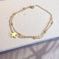 Detailed view of double-layer gold stainless steel bracelet with star pendant and beads - Gold - Star