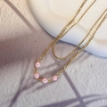 Close-up of double-layer gold snake chain with pink enamel evil eye beads detail - Gold-Pink