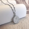 Vue détaillée du pendentif pièce en argent avec texture martelée et gravure étoile polaire - Argenté