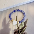 Dettaglio dell'anello in pietre naturali con ciondolo a cuore bianco e accenti dorati - Cuore - Sodalite