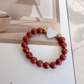 Elastic beaded ring with natural red stone beads, gold spacers and a white heart bead - Red Stone with White Heart Shell Charm