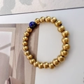 Detail of beaded gold stretch ring featuring a single dark blue lapis lazuli stone - Lapis Blue Plain Ring Style
