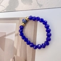 Minimalist lapis lazuli stretch ring featuring dark blue faceted beads and gold accents - Lapis Blue Style A