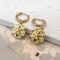Detailed macro of gold starfish drop earrings with star pattern and hammered texture - Starfish Earrings / Gold