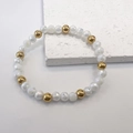 Detail of 6mm milky faceted beads and golden polished beads on an elastic bracelet - White-Gold