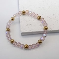 Detailed view of faceted pink glass beads and golden stainless steel ball bracelet - Pink-Gold