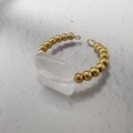 Macro view of a 18K gold stainless steel ring with beaded band and rectangular white stone - Rose Quartz