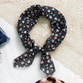 Chic black cotton-linen square scarf with orange daisy floral print tied in a knot - Black White Daisy