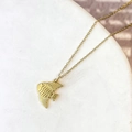 Macro shot of gold-plated fish pendant with wave scale texture on marble background - Fish Style (DN271)