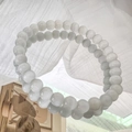 Macro shot of white cat eye stone beaded bracelets with elegant reflective surface - 6mm / White