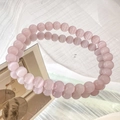 Detailed macro view of two pink cat eye stone beaded bracelets with glossy mirror reflections - 6mm / Pink
