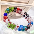 Macro shot of colorful glass beads with red heart patterns on a beaded elastic bracelet - Round - 6mm