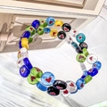 Close-up of vibrant elastic bracelet featuring colorful glass beads with heart patterns - Flat Bead - 8mm