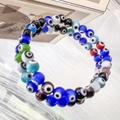 Macro view of multi-colored Evil Eye glass beads on a stretch bracelet with 6mm beads - 6mm Rainbow