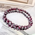 Detail of 6mm deep purple evil eye glass beads on elastic bracelets with mirror reflection - 6mm Fuchsia