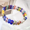 Details von zwei handgefertigten Millefiori-Glasperlenarmbändern mit bunten Blumenmustern - 6mm Regenbogen