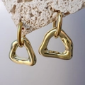 Macro view of gold geometric hollow triangle earrings with a molten texture on stone - Gold