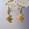 Detailed macro of 18K gold fish drop earrings on white rock with purple backdrop - Tropical Fish Style (DE181-p271)